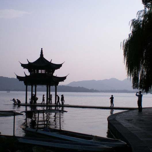 An evening photo of a lake with a gazebo